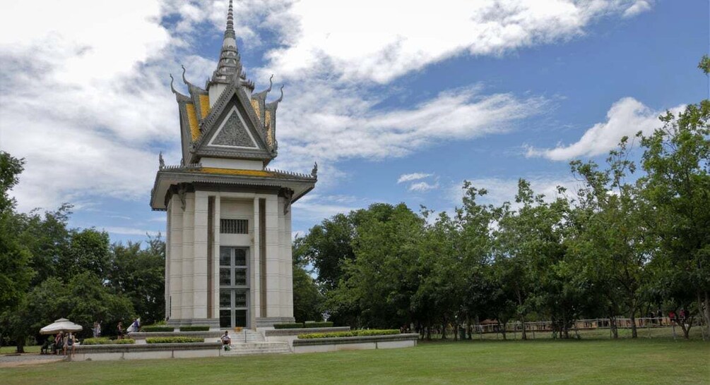 A temple with a spire, surrounded by a well-maintained lawn and trees. 3