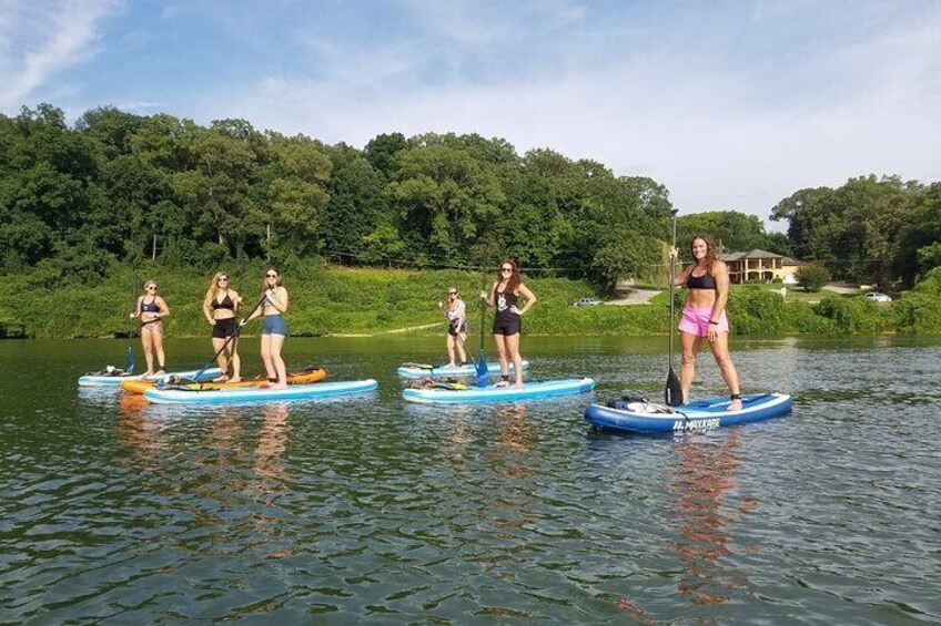 Chattanooga water adventures; kayaking, whitewater rafting, and paddleboarding.  image of girl standing on paddle board in Tennessee River.
