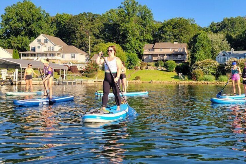 Chattanooga water adventures; kayaking, whitewater rafting, and paddleboarding.  image of girl standing on paddle board in Tennessee River.