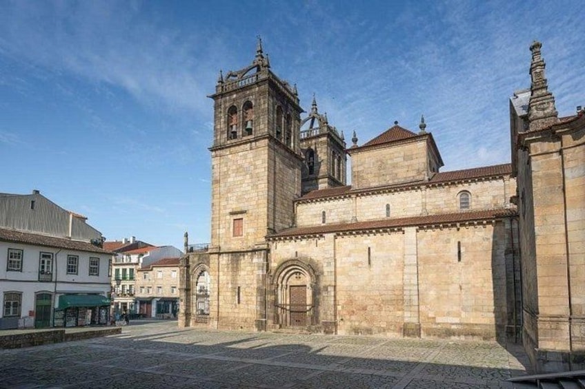 A historic building with a prominent tower and arched entrance. 2