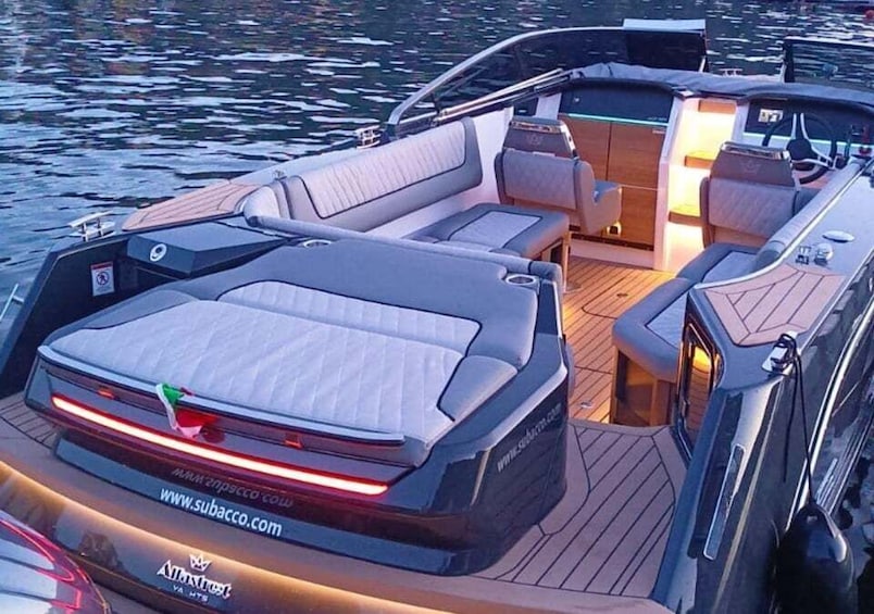 A boat with a covered seating area, a steering wheel, and a website URL on the back. 2