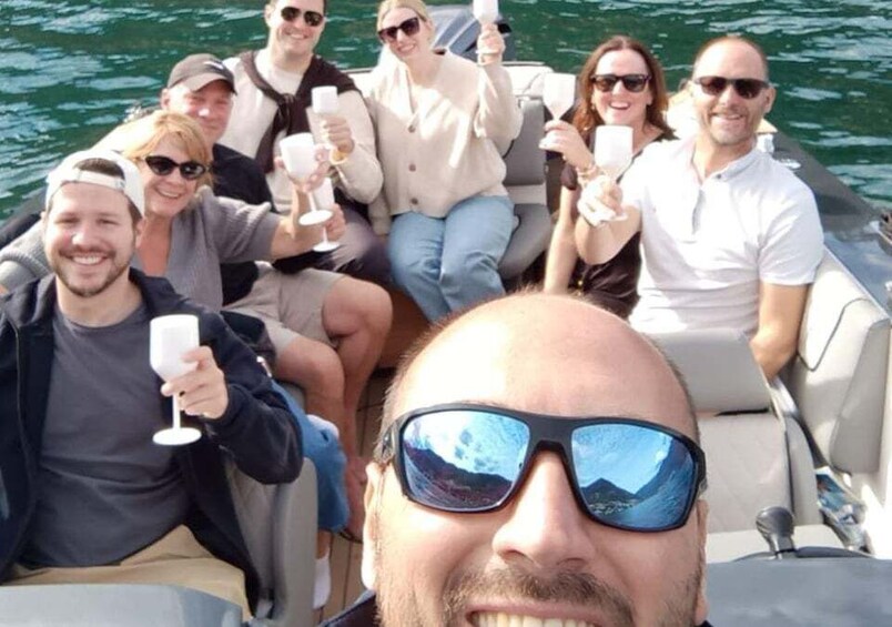 A group of people on a boat, holding glasses, likely celebrating. 4