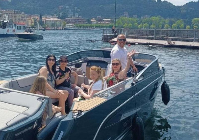 A group of people on a boat with a cityscape in the background. 3