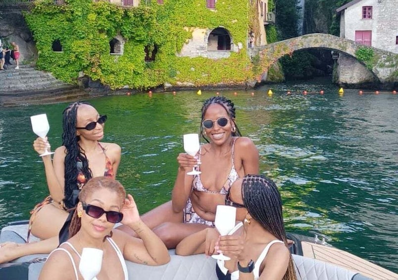 A group of people on a boat in a canal with buildings and a bridge in the background. 5