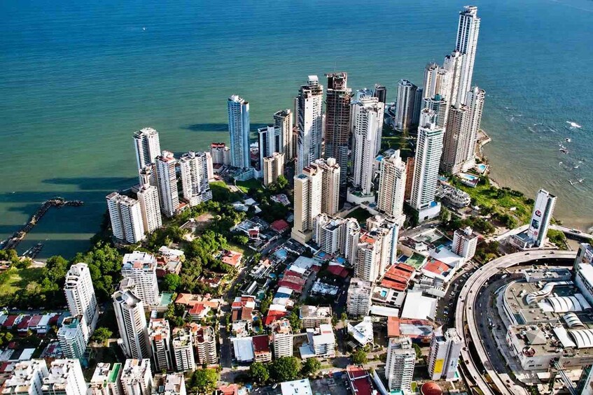A coastal cityscape with high-rise buildings and a marina. 4