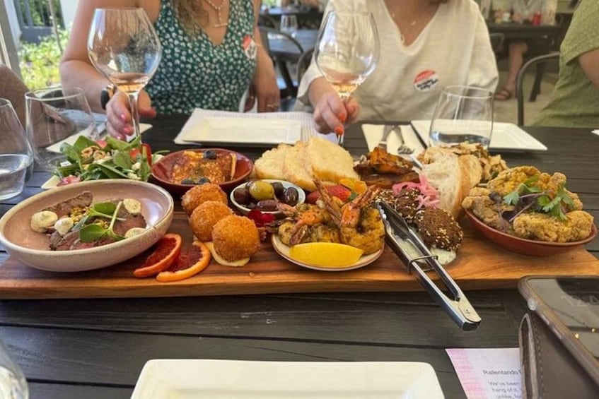 A table with various dishes and wine glasses. 2