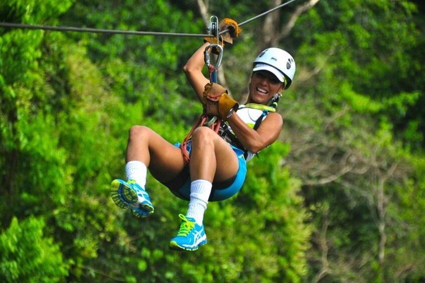 A person ziplining through a forest. 3