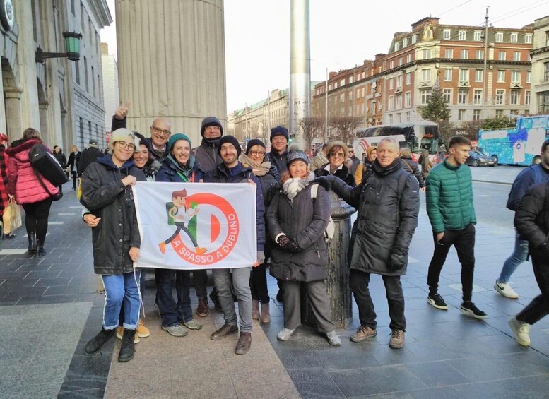 A group of people holding a banner with a running figure and text. 3
