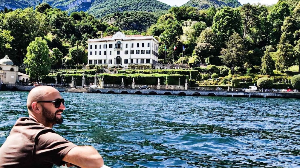 A man on a boat, a white building with a garden, and a mountainous landscape. 3