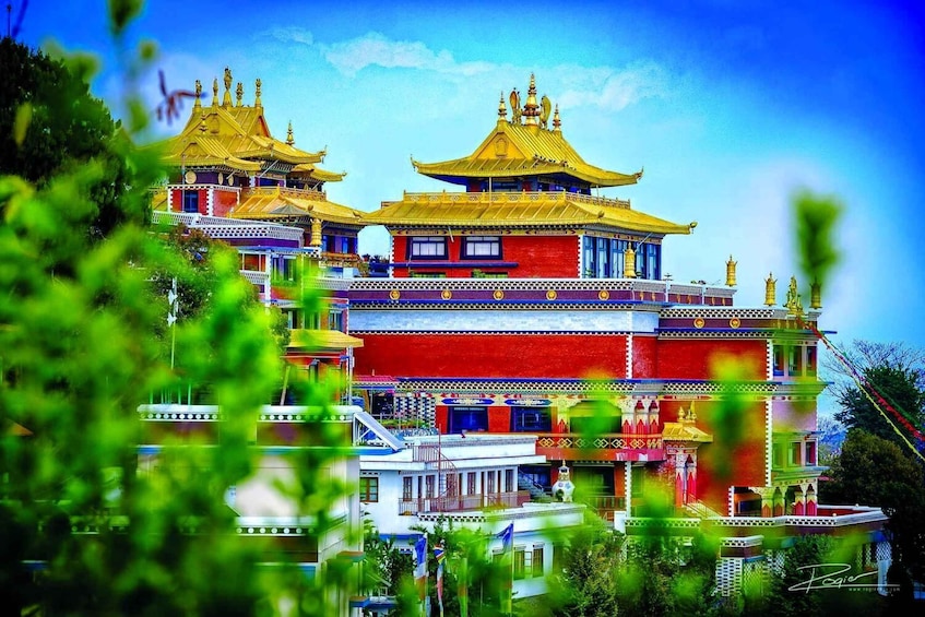 A colorful traditional building with multiple tiers and golden roofs. 1