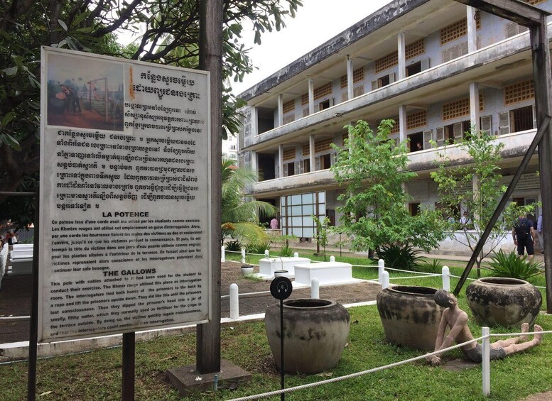 A historical building with a signboard and a rope barrier. 4
