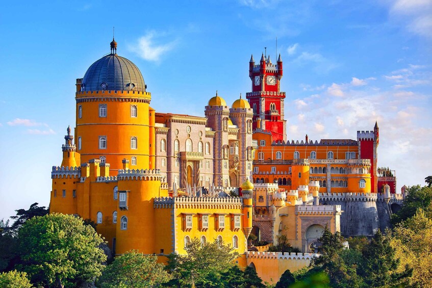 A historic castle with a prominent clock tower, domed structures, and ornate architecture. 1