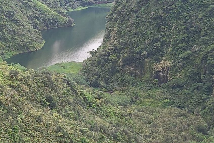 A river winding through a forested valley. 2