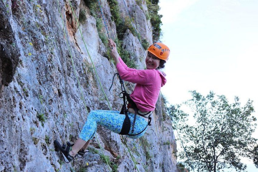 A person climbing a rocky cliff. 3