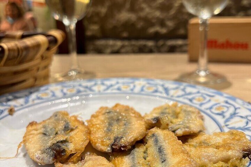 Un piatto di pesce fritto con un decoro blu e bianco. 2