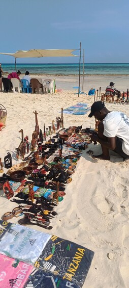 A beach market with various items for sale, including figurines and souvenirs. 5