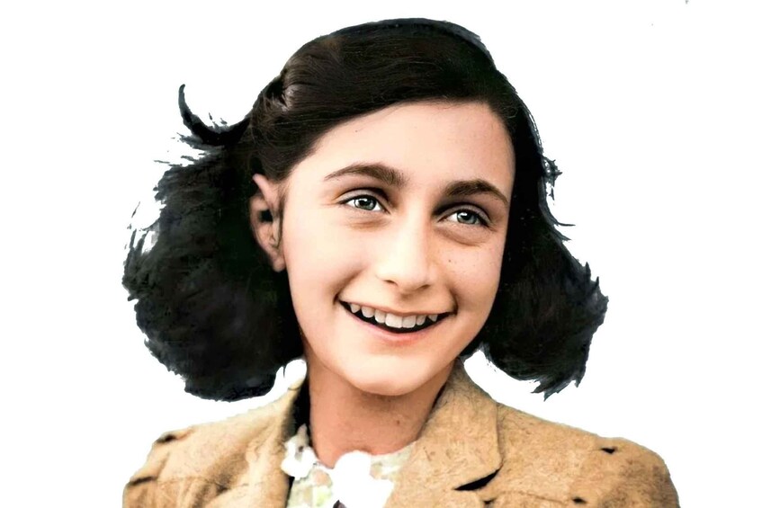 A person with dark hair wearing a light-colored jacket. 1