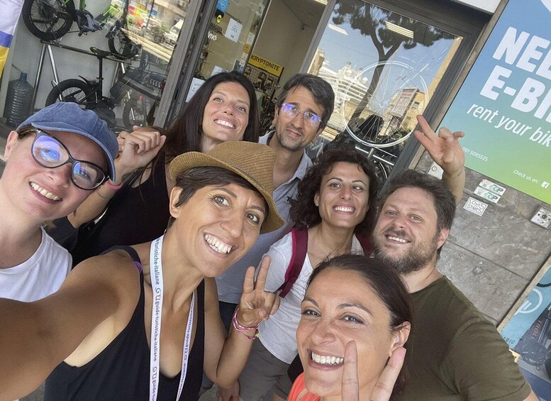 A group of people posing in front of a bicycle rental shop. 4