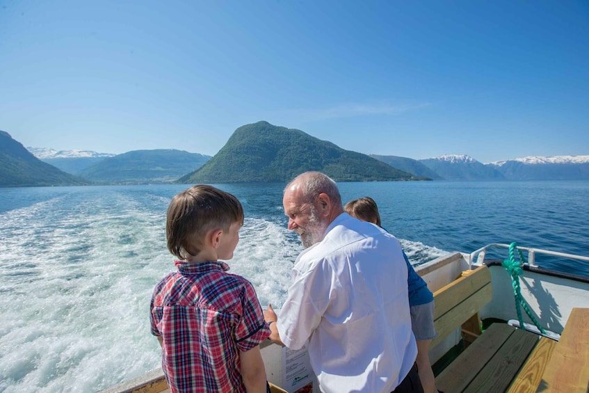 A boat on a lake with mountains in the background. 5
