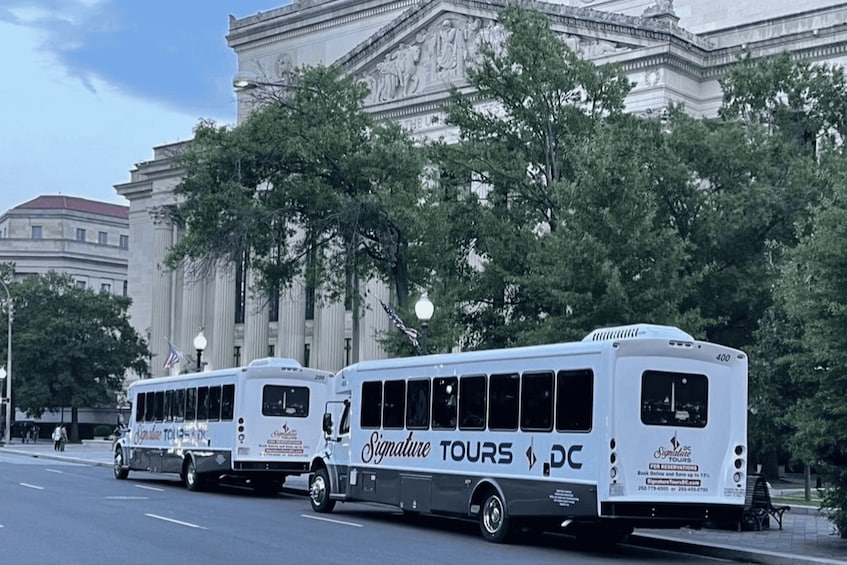 Three Signature Tours buses parked in front of a large neoclassical building with columns. 2