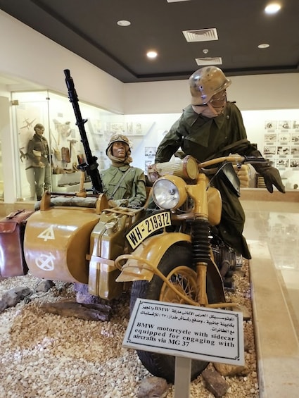 A BMW motorcycle with a sidecar, displayed in a museum. 4