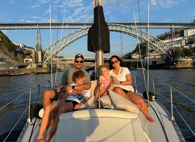 A family on a boat with a bridge in the background. 2
