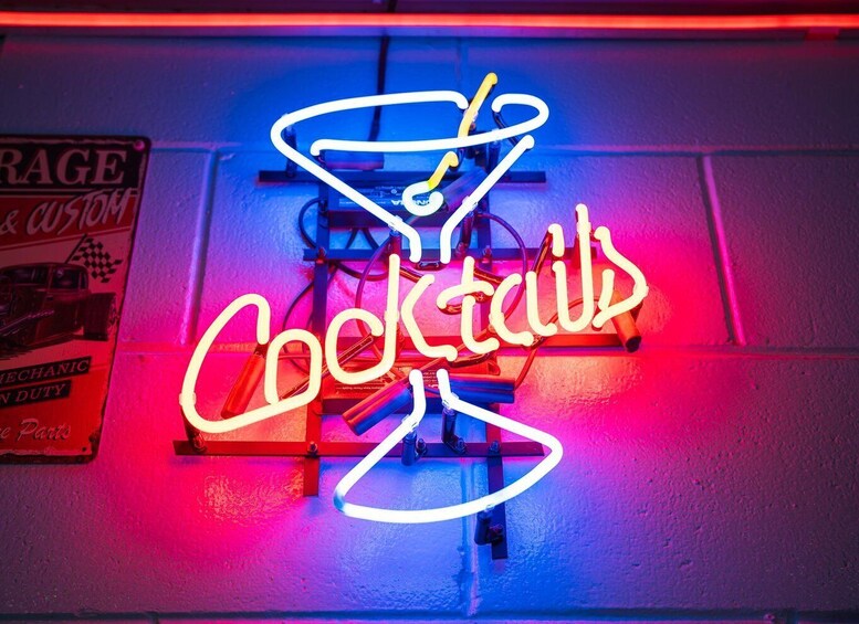 A neon sign with the word 'Cocktails' and a cocktail glass. 2