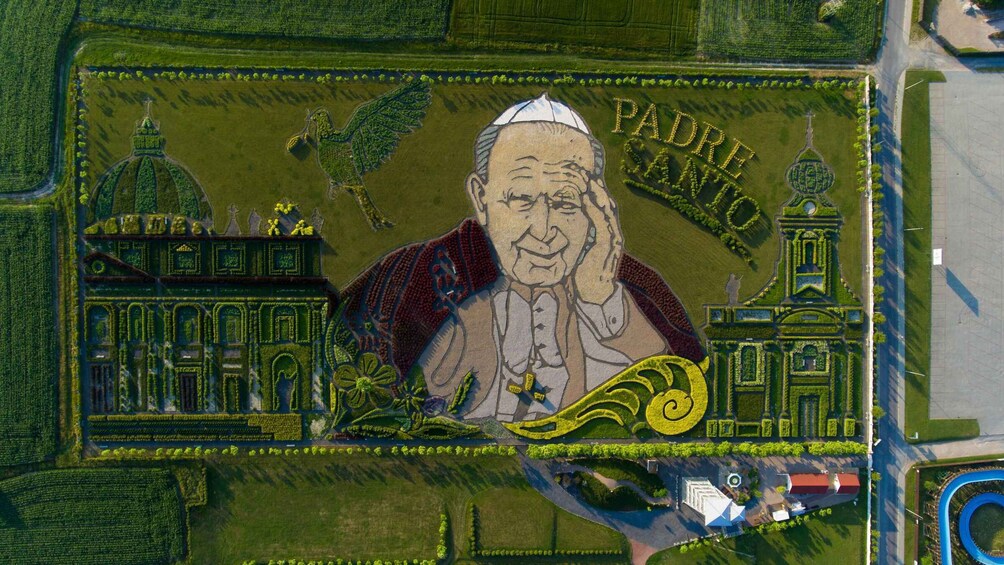 A detailed garden with a central statue, surrounded by various architectural structures and pathways. 3
