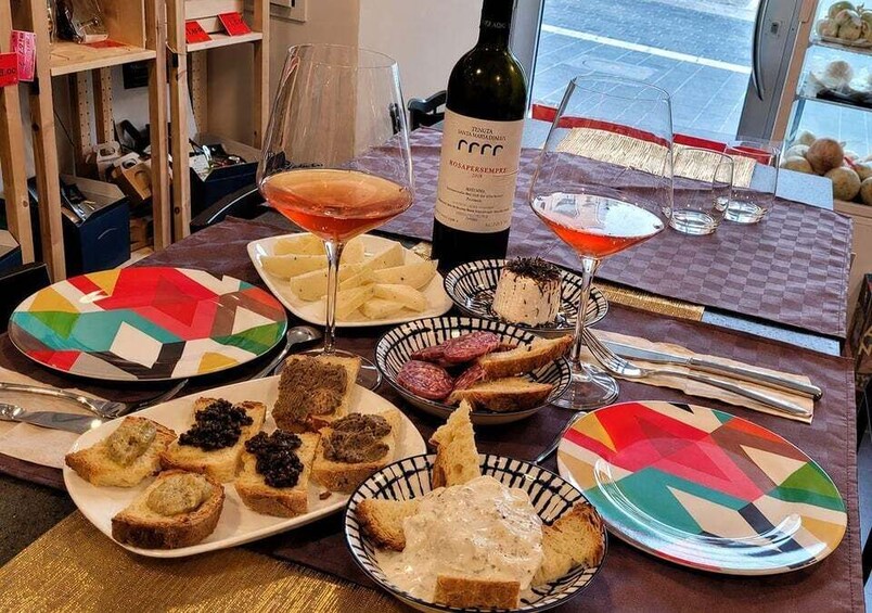 A table with various dishes, glasses, and a bottle of wine. 1