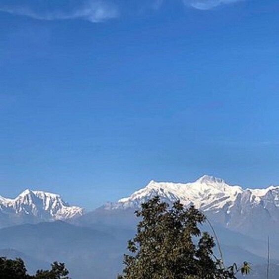 A mountain range with snow-capped peaks under a clear blue sky. 5