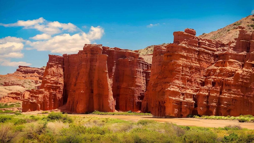 A desert landscape with red rock formations and a clear blue sky. 4