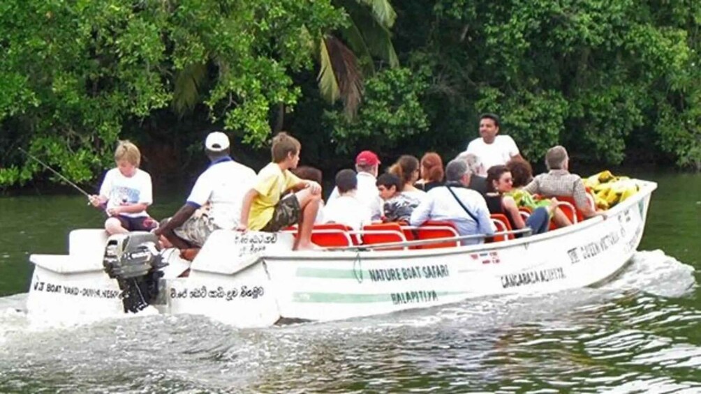 A boat with passengers, surrounded by dense green foliage. 3