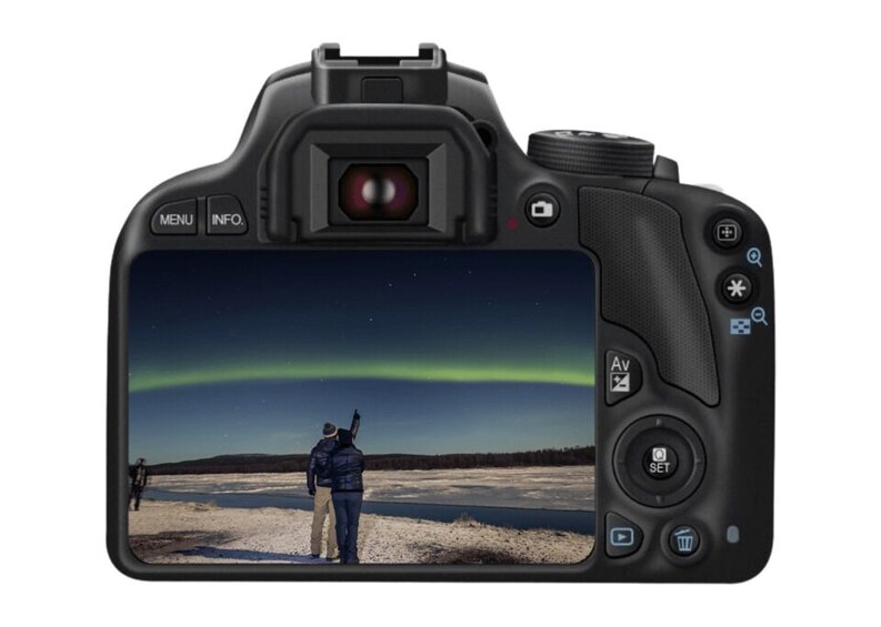 A camera with a view of the Northern Lights over a snowy landscape. 1