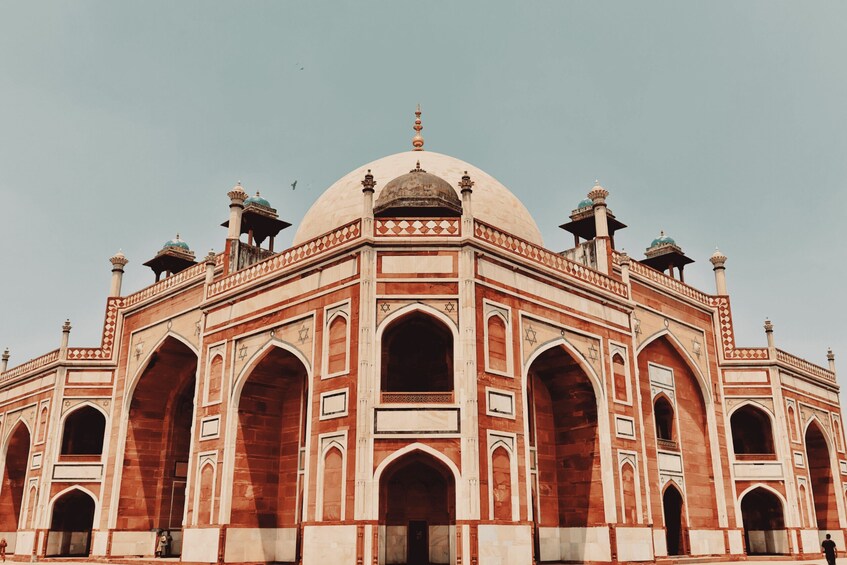 A large, ornate building with a central dome and multiple arches. 5