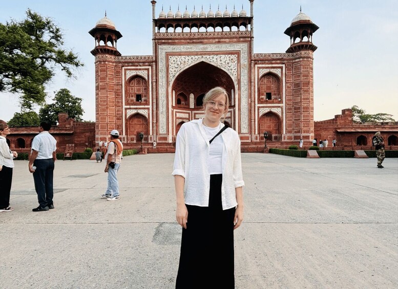 A large, ornate red-brick structure with domes and intricate carvings, likely a historical monument. 5