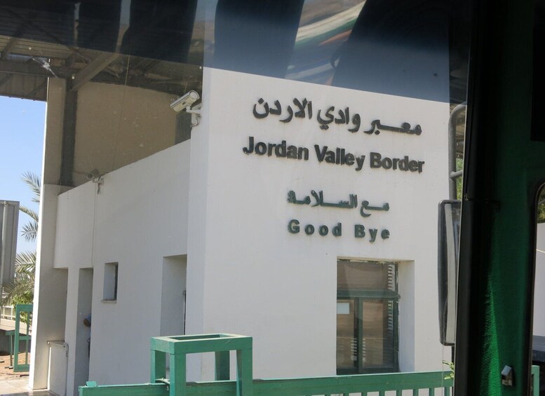 A sign with 'Jordan Valley Border' and 'Good Bye' written in both Arabic and English. 5