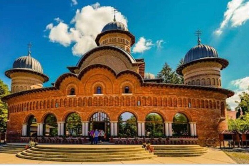 A large brick building with multiple domes and arched windows. 5