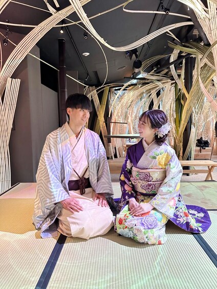 Two people in traditional Japanese attire sitting on tatami mats. 5