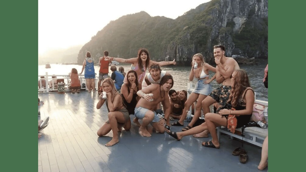 A group of people on a boat near a rocky coastline. 2