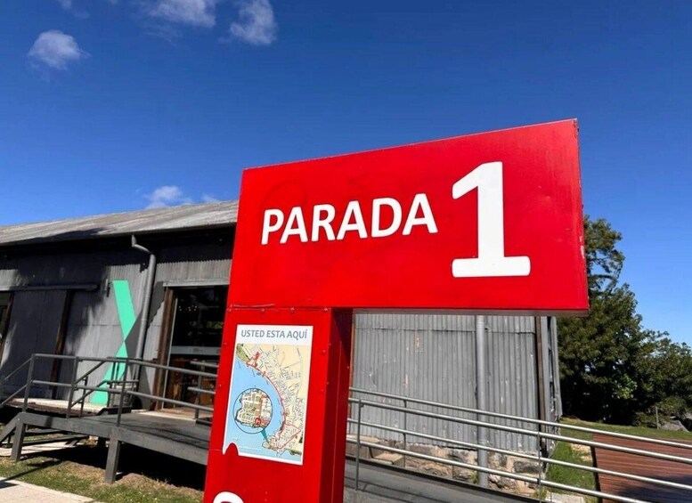 A red sign with 'PARADA 1' and a map indicating a location. 1
