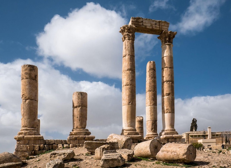 Ancient stone columns and ruins under a clear sky. 2