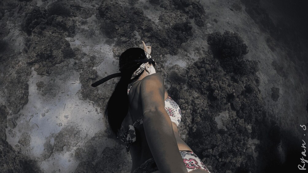 A person snorkeling underwater. 4