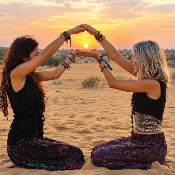 Two people forming a heart shape with their hands against a sunset backdrop. 3