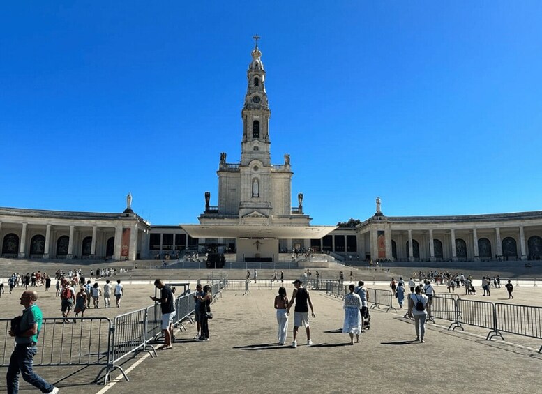 A large plaza with a prominent church featuring a tall bell tower and statues. 4