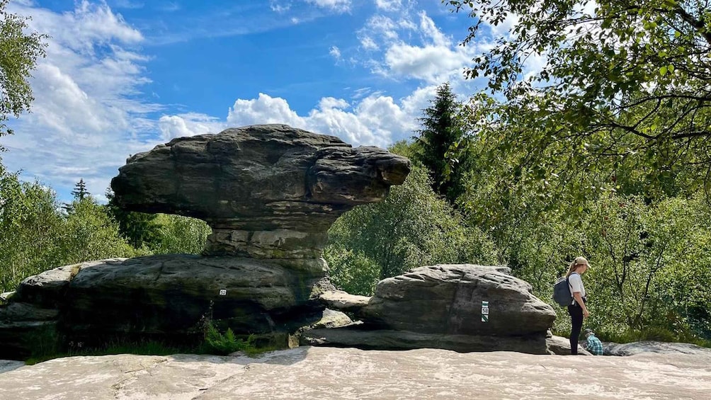 A natural rock formation with a person standing nearby. 4