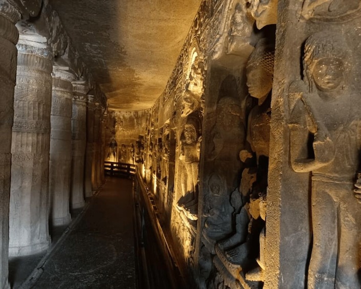 A corridor with ancient stone carvings and columns. 4