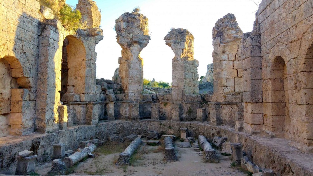 Ancient ruins with stone arches and columns. 4
