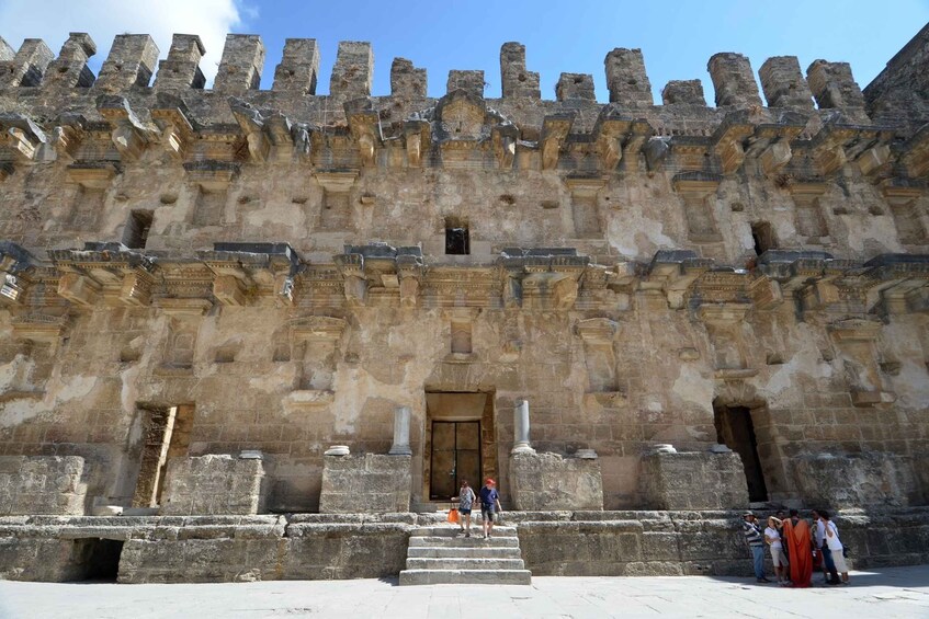 A historic stone fortress with battlements and a central entrance. 2