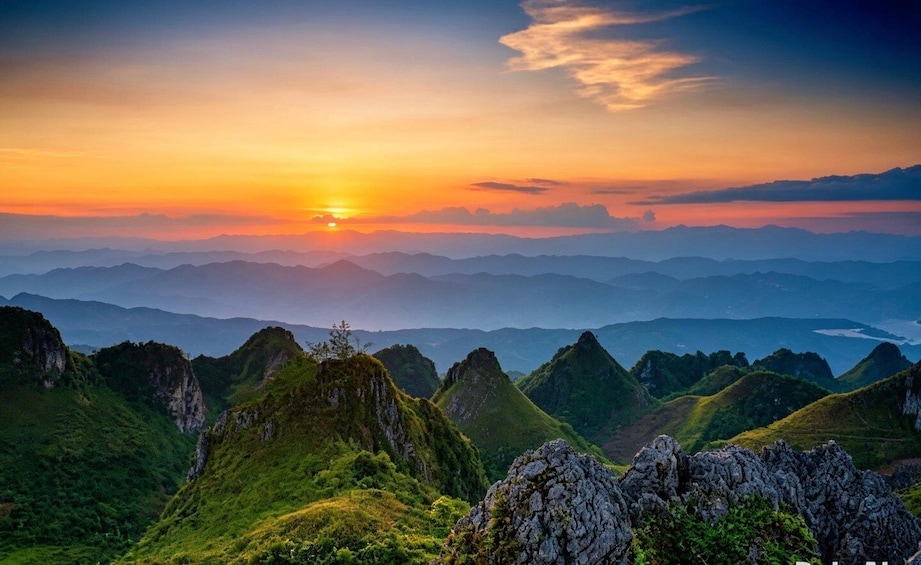 A mountainous landscape with a sunset. 1