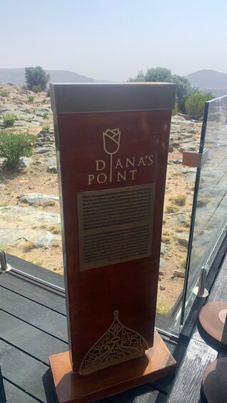 A sign with 'Diana's Point' and a flower logo. 5